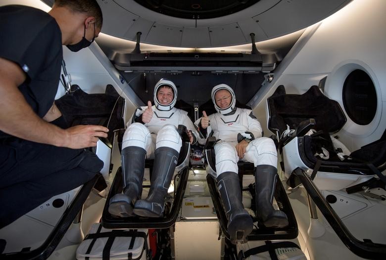 NASA astronauts Robert Behnken, left, and Douglas Hurley are seen inside the SpaceX Crew Dragon Endeavour spacecraft onboard the SpaceX GO Navigator recovery ship shortly after having landed in the Gulf of Mexico off the coast of Pensacola, Florida, August 2, 2020. NASA/Bill Ingalls/Handout via REUTERS